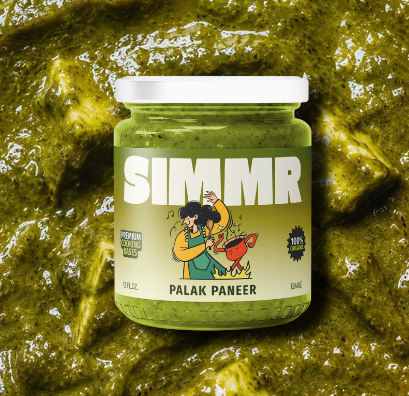 Jar of SIMMR Palak Paneer cooking base resting on a bed of its sauce