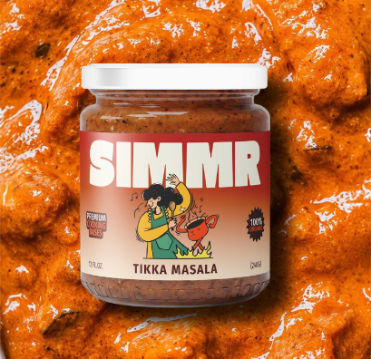 Jar of SIMMR Tikka Masala cooking base resting on a bed of its sauce